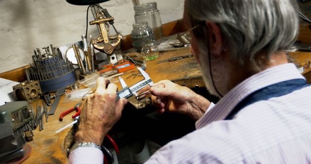 Senior Craftsman Using Caliper in Workshop - Download Free Stock Images Pikwizard.com