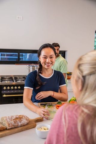 Diverse Friends Enjoying Breakfast Preparation in Modern Kitchen