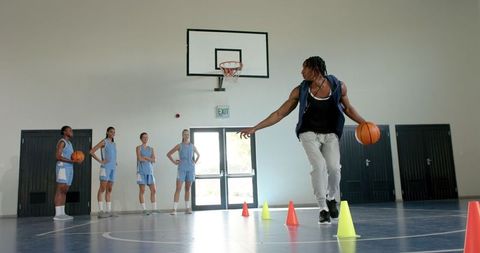 Basketball Coach Dribbling with Cones