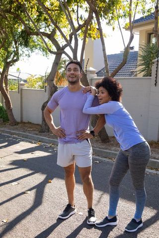 Active couple energized in urban nature during run