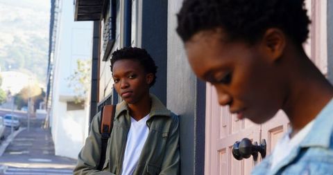 Twin sisters sharing quiet moment in city urban lifestyle