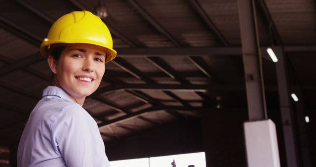 Woman Engineer Wearing Yellow Hard Hat in Warehouse Environment - Download Free Stock Images Pikwizard.com