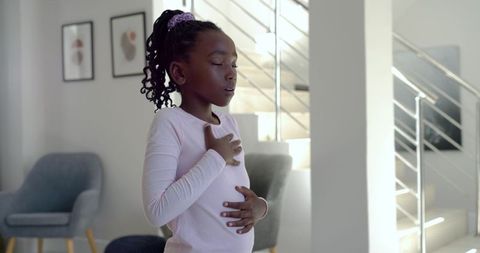 African american girl practicing mindful breathing at home for calm and focus