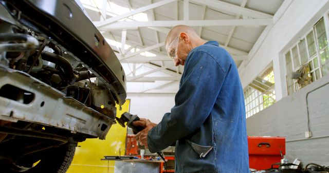 Experienced Mechanic Repairing Vehicle in Workshop - Download Free Stock Images Pikwizard.com