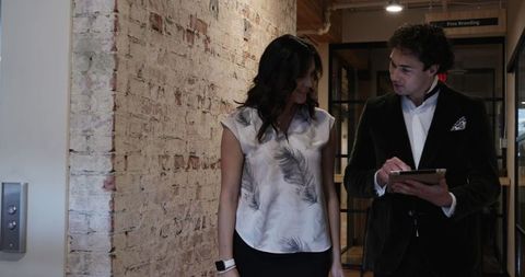 Business Colleagues Discussing Work in Modern Office Hallway