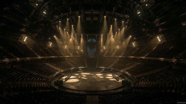 Dramatic Lighting Illuminating Circular Stage in Large Arena