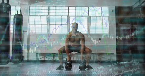Shirtless athlete squatting gripping kettlebells in warehouse gym with market charts