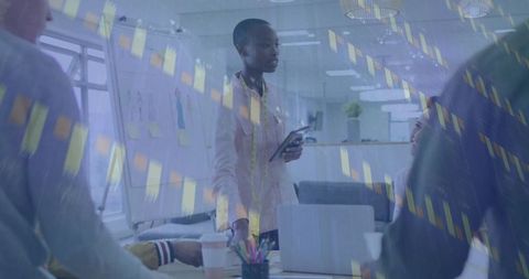 Professional Woman Presenting Digital Finance Charts in Collaborative Meeting