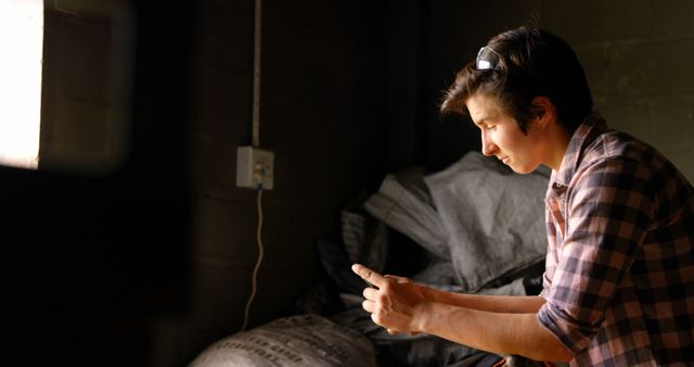 Young Farmer Checking Mobile Phone in Barn - Download Free Stock Images Pikwizard.com