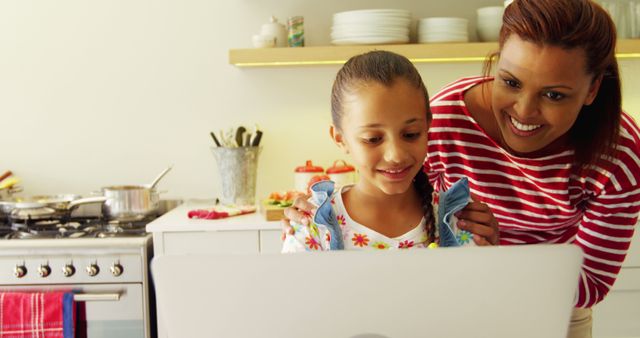 Mother and Daughter Enjoying Quality Time with Laptop in Kitchen - Download Free Stock Images Pikwizard.com