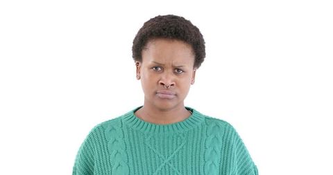 Confused woman in green sweater isolated on white background