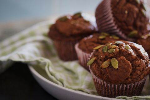 Pumpkin spice muffins with pumpkin seeds on plate