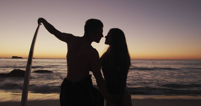 Romantic Couple Silhouette on Beach During Sunset with Surfboard - Download Free Stock Images Pikwizard.com