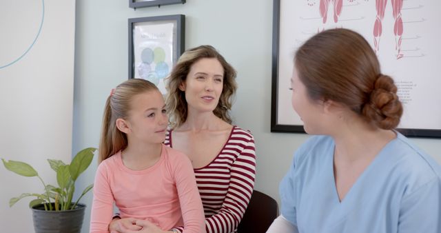 Friendly Pediatrician Consulting with Mother and Daughter in Medical Office - Download Free Stock Images Pikwizard.com