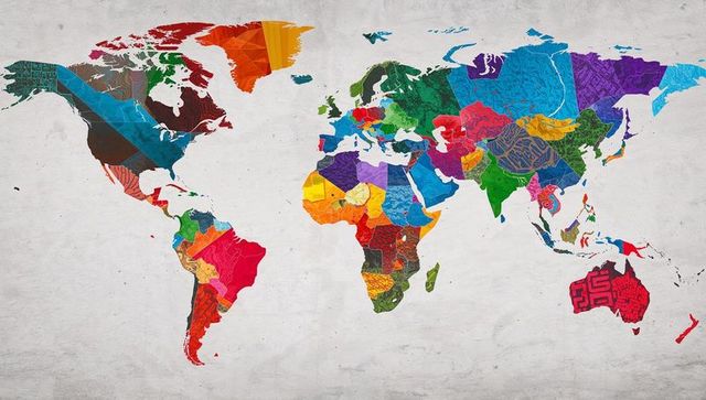 Vibrant mosaic world map mural featuring patterned country shapes and geometric textures