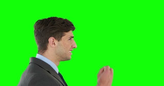 A Caucasian businessman in a suit appears to be talking or presenting, with copy space on the green background. His expression and gesture suggest he's making a point or explaining a concept.