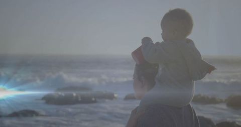 Mother with Infant at Sunset Beach Embracing Serenity