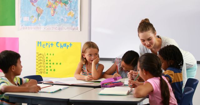 Female teacher interacting with diverse students in classroom - Download Free Stock Images Pikwizard.com