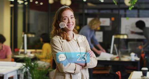 Confident female team leader smiling with message notifications in modern coworking office