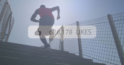 Silhouette of Man Running Up Stairs Outdoors with Social Media Overlay