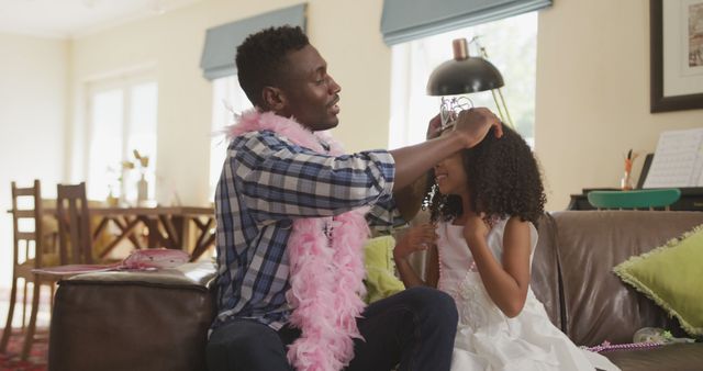 Smiling father and daughter enjoying dress-up game together - Download Free Stock Images Pikwizard.com