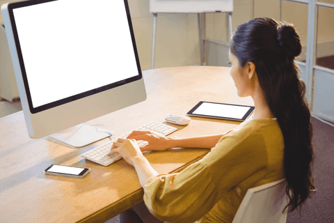 businesswoman at desk working on computer with gadgets visible - Download Free Stock Videos Pikwizard.com