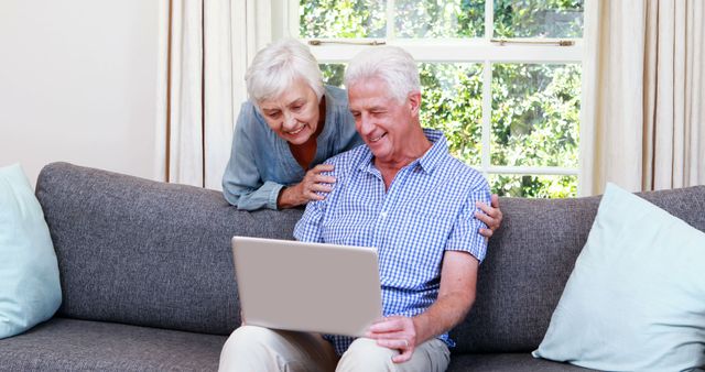 Happy Senior Couple Using Laptop on Couch - Download Free Stock Images Pikwizard.com