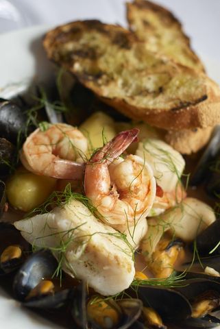 Gourmet seafood platter with grilled bread and fresh herbs
