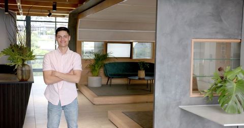 Confident Professional Standing in Stylish Modern Office Lobby