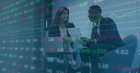 Business Professionals Analyzing Financial Growth with Digital Devices