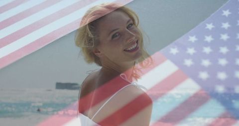 Smiling Woman With US Flag Overlay at Beachside Getaway
