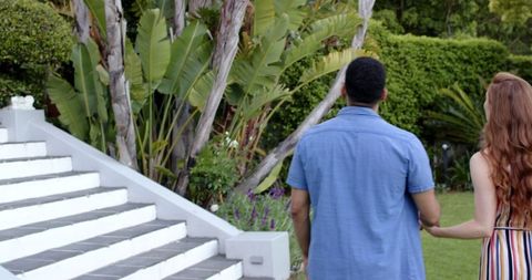 Romantic garden proposal with multiracial couple