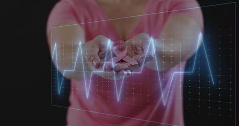 Woman Holding Pink Ribbon with Holographic ECG Overlay