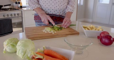 Slicing Fresh Vegetables for Healthy Cooking in Modern Kitchen