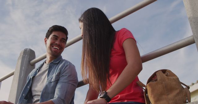 Happy Young Couple Enjoying Outdoor Conversation Under Blue Sky - Download Free Stock Images Pikwizard.com