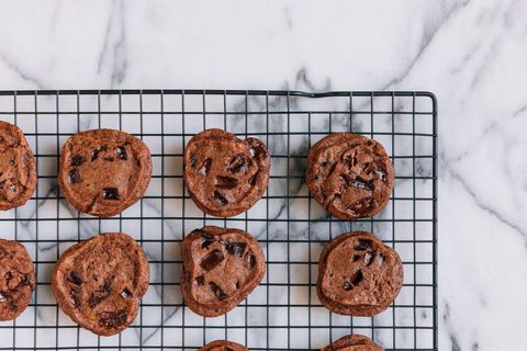 Freshly baked chocolate chunk cookies cooling on rack