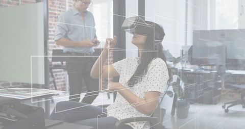 Female professional using vr headset with holographic interface in modern open office