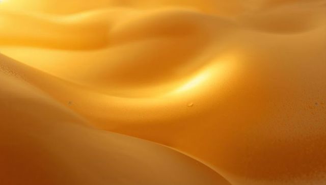Glowing golden liquid surface with droplet and smooth curves for luxury abstract