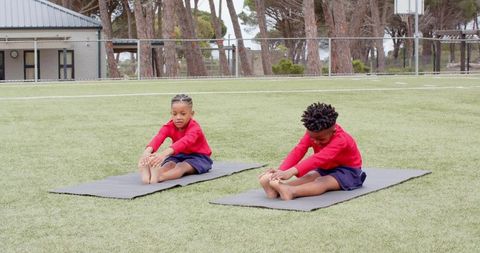 Children Practicing Yoga on Outdoor Field with Exercise Mats