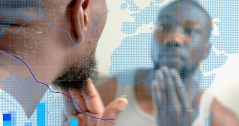 Man inspecting beard in mirror with blue digital overlays and world map, grooming tech