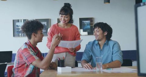 Colleagues engaged in collaborative office meeting