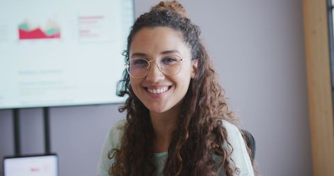 Smiling Businesswoman with Glasses in Modern Office