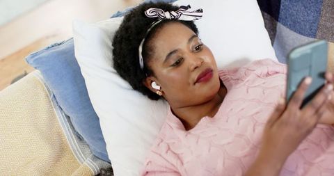 Relaxed Woman Listening to Music at Home on Couch