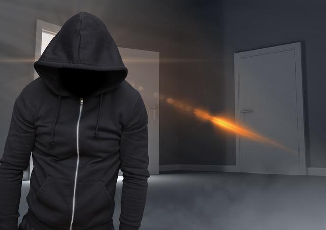 Digital composite of Anonymous criminal in hood in front of door