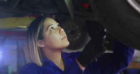Female Mechanic Inspecting Vehicle Undercarriage in Auto Repair Garage - Download Free Stock Images Pikwizard.com
