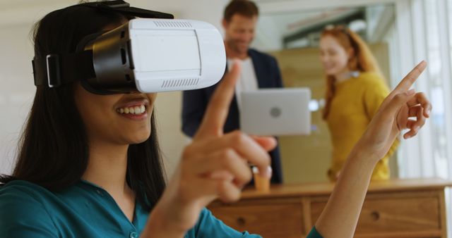 Smiling Woman Using Virtual Reality Headset in Modern Office - Download Free Stock Images Pikwizard.com