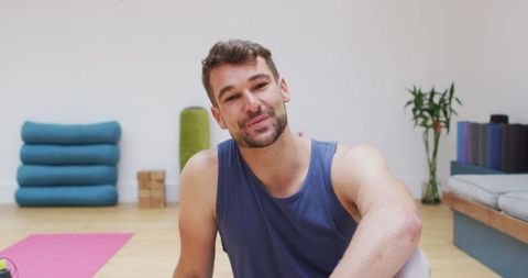 Cheerful Yoga Instructor Relaxing in Modern Studio