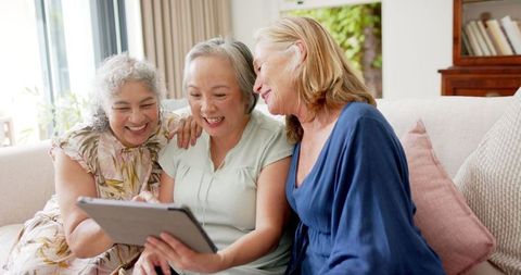 Senior Women Enjoying Tablet Time Laughing Together on Sofa - Download Free Stock Images Pikwizard.com