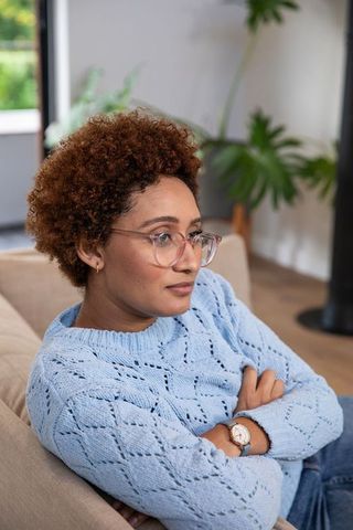 African american woman relaxing on cozy living room couch