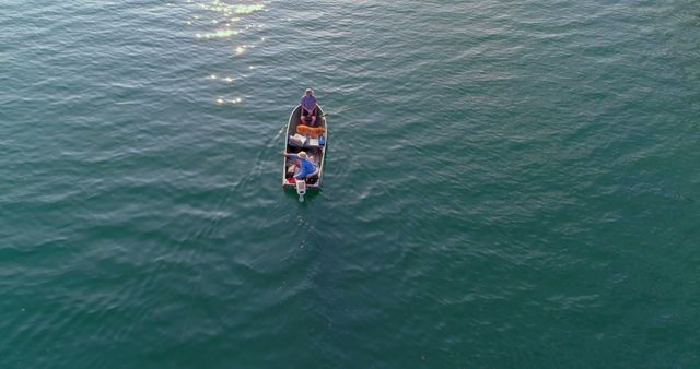 Aerial View of Man in Small Boat on Tranquil Water - Download Free Stock Images Pikwizard.com